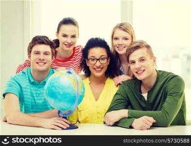 education, travel and geography concept - five smiling student with earth globe at school