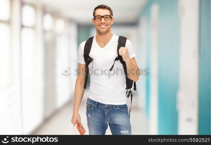 education, travel and vacation concept - smiling student in eyeglasses with backpack and book