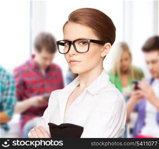 education, vision, optics concept - attractive student wearing glasses in college