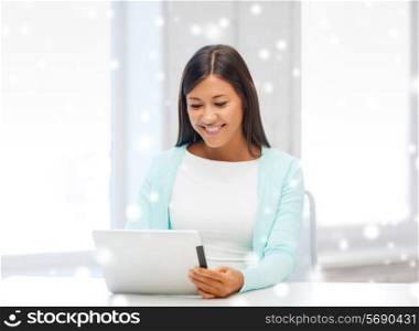 education, winter, technology and people concept - smiling young woman with tablet pc computer indoors