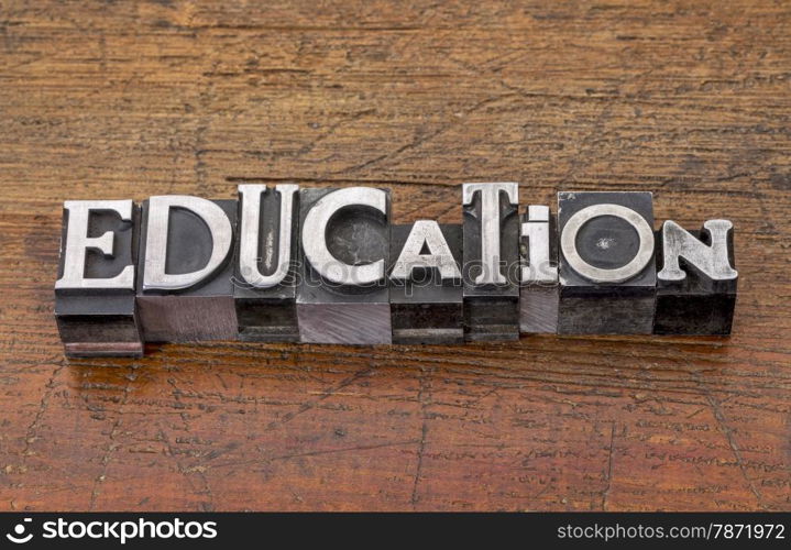 education word in mixed vintage metal type printing blocks over grunge wood