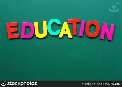 Education - word made of colorful letters on a greenboard