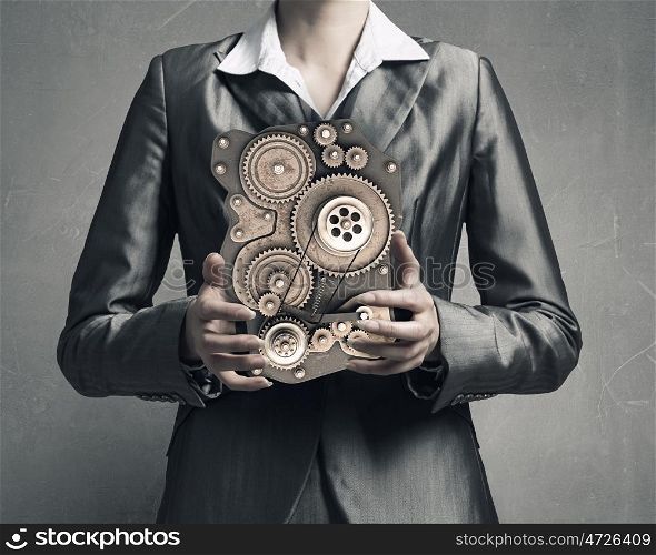 Effective working mechanism. Close up image of businesswoman holding gears mechanism in hands