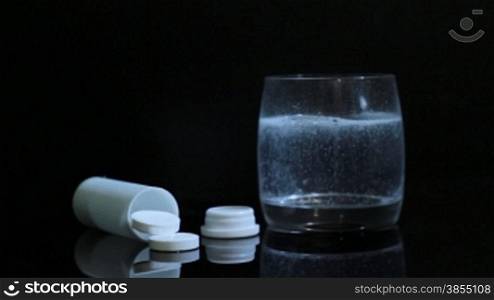 effervescent tablet of aspirin in a glass of water. video shot slider DITOGEAR.