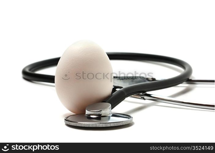 egg and a medical stethoscope isolated on a white backgrounds