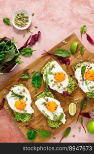 Egg and avocado toast, sandwiches with eggs and fresh greens. Hea<hy diet food. Top view