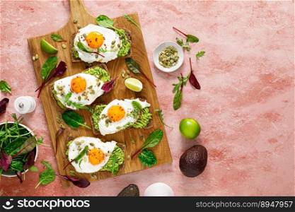 Egg and avocado toast, sandwiches with eggs and fresh greens. Healthy diet food. Top view