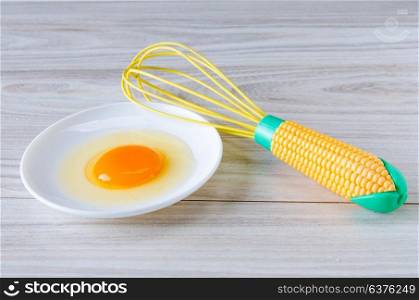 Egg in bowl and balloon whisk