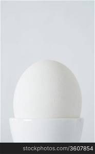 Egg in egg cup, close up, studio shot