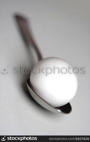 Egg on spoon - studio shot