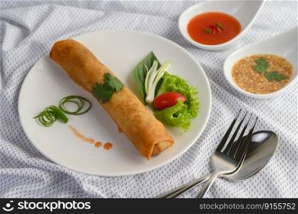 Egg roll or Fried Spring Rolls on the white plate Thai food. Selective focus.
