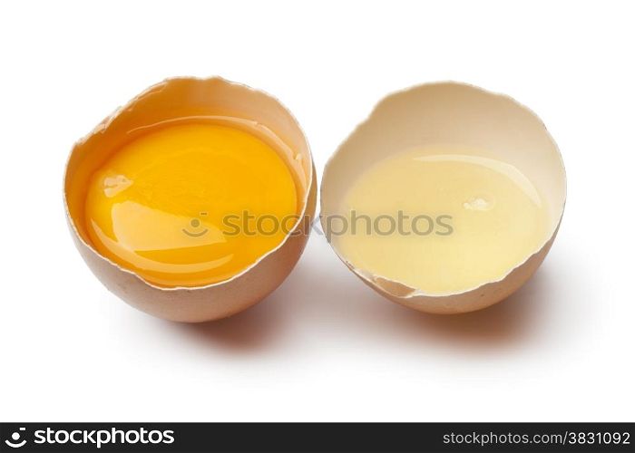 Egg yolk and white in a broken brown egg shell on white background
