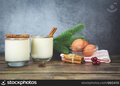 Eggnog delicious holiday drinks like themed parties with cinnamon and nutmeg for Traditional Christmas and winter holidays Homemade eggnog in glasses and fresh eggs decorated on the table
