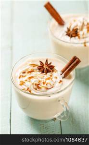 Eggnog. Traditional Christmas drink, spiced egg-milk cocktail with cream caramel topping.