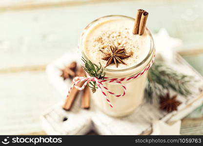 Eggnog. Traditional Christmas drink, spiced egg-milk cocktail with nut topping.