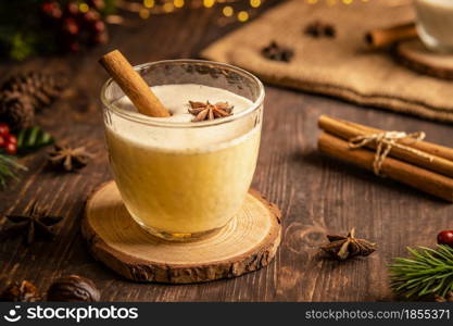 Eggnog with spicy cinnamon for Christmas and winter holidays,Cozy cocktail with milk and cinnamon and clove stars,Traditional Christmas drink with grated nutmeg and cinnamon,Homemade White Holiday