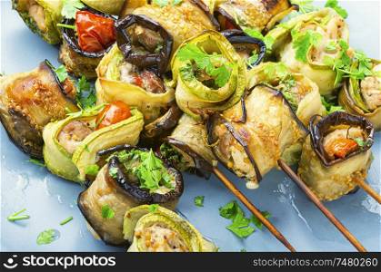 Eggplant and zucchini stuffed with chicken meat on skewers.Banquet snack. Eggplant with meat on skewers