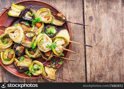 Eggplant and zucchini stuffed with chicken meat.Skewers of grilled meat and vegetables. Eggplant with meat on skewers