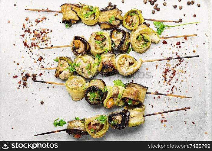 Eggplant and zucchini stuffed with meat on skewers. Eggplant with meat on skewers