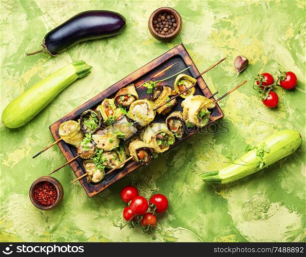 Eggplant and zucchini stuffed with meat on skewers.Flat lay with copy space. Eggplant with meat on skewers