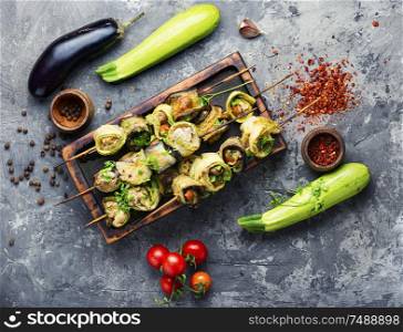 Eggplant and zucchini stuffed with meat on skewers.Flat lay with copy space. Eggplant with meat on skewers