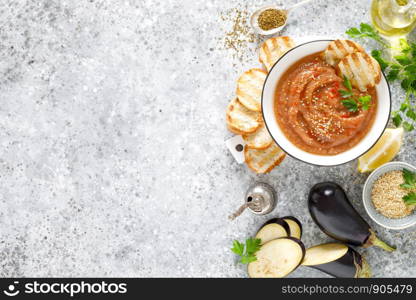 Eggplant hummus with ingredients for cooking. Traditional vegan arabic aubergine appetizer. Baba Ghanoush