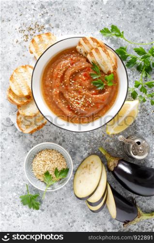 Eggplant hummus with ingredients for cooking. Traditional vegan arabic aubergine appetizer. Baba Ghanoush