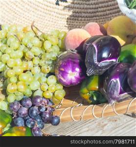 eggplant peppers grapes. Fruits and vegetables in season exposed in a street market