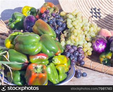eggplant peppers grapes. Fruits and vegetables in season exposed in a street market