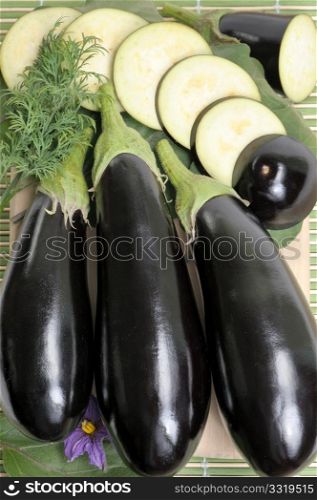 Eggplants of black colour and the cut slices