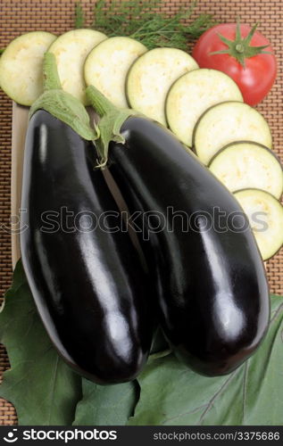 Eggplants of black colour and the cut slices