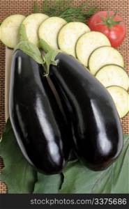 Eggplants of black colour and the cut slices