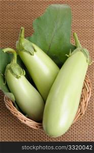 Eggplants of green colour in a basket