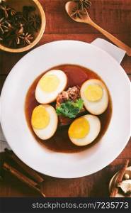 Eggs and pork in brown sauce,Thai Cuisine,shallow Depth of Field,Focus on pork. . Eggs and pork in brown sauce.