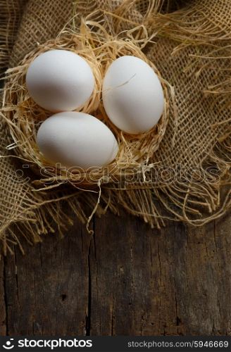 eggs at hay nest on old table wood