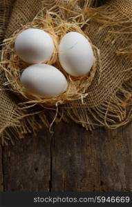 eggs at hay nest on old table wood