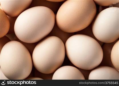 Eggs background. Fresh brown chicken eggs. Top view