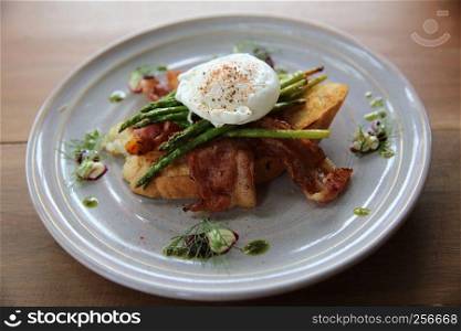 eggs benedict poached egg on bacon asparagus and bread breakfast