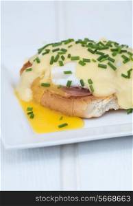 Eggs Benedict toasted English muffins ham poached eggs and delicious buttery hollandaise sauce