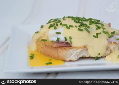 Eggs Benedict toasted English muffins ham poached eggs and delicious buttery hollandaise sauce