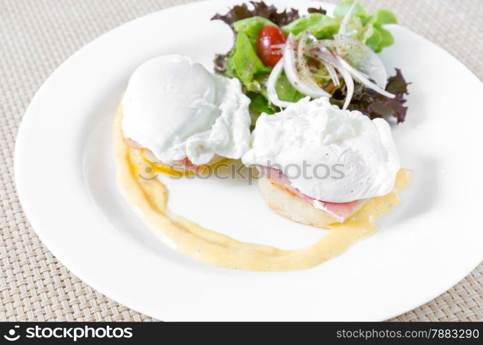 Eggs Benedict- toasted English muffins, ham, poached eggs, and delicious buttery hollandaise sauce for breakfast