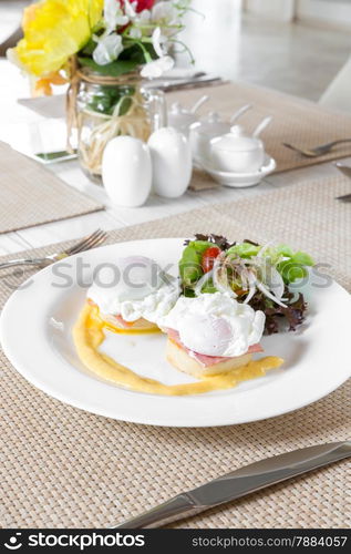 Eggs Benedict- toasted English muffins, ham, poached eggs, and delicious buttery hollandaise sauce for breakfast