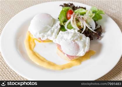 Eggs Benedict- toasted English muffins, ham, poached eggs, and delicious buttery hollandaise sauce for breakfast