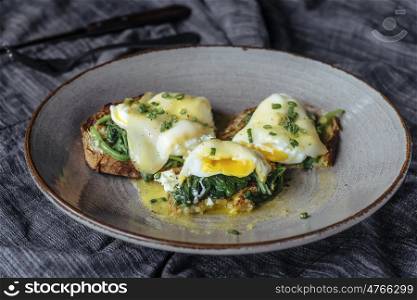 Eggs benedicts on toast, close up view.