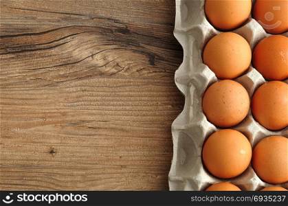 Eggs displayed in a carton on a wooden table