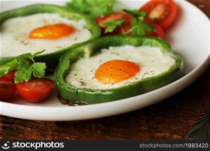 Eggs Fried in Bell Pepper Ring on wooden table. Eggs Fried in Bell Pepper Ring