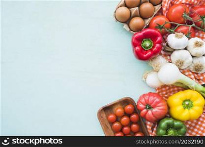 eggs healthy vegetables blue colored background
