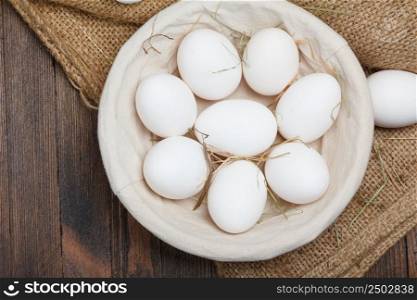 Eggs in a bowl on wooden table