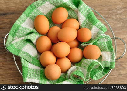 Eggs in a green cloth inside a wire basket