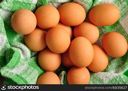 Eggs in a green cloth inside a wire basket